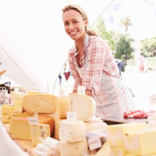 Woman,Selling,Fresh,Cheese,At,Farmers,Food,Market