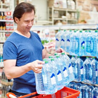 Man,Buy,Big,Plastic,Bottles,Of,Drinking,Water,In,Store