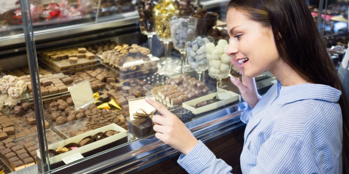 Young,Woman,Buying,Fine,Chocolates,And,Confectionery