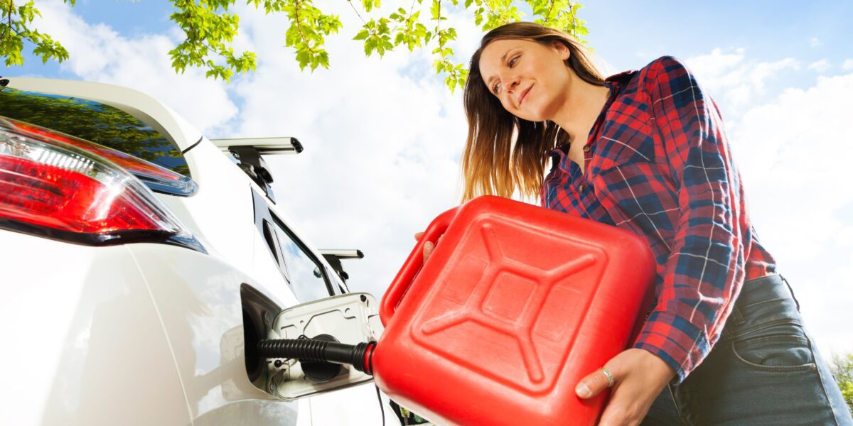 Woman,Pouring,Fuel,Into,Gas,Tank,Of,A,Car,From